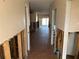 A hallway that has been partially remodeled to reveal the underlying framework of the house at 13811 Michelle Ave, Hudson, FL 34667