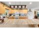 Well-lit kitchen with large island, light wood cabinets, and stainless steel appliances at 13811 Michelle Ave, Hudson, FL 34667