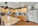 Spacious kitchen with marble countertops, tile backsplash, and light wood cabinetry at 13811 Michelle Ave, Hudson, FL 34667