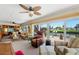 Bright living room with ceiling fan features water view, multiple seating options at 13811 Michelle Ave, Hudson, FL 34667