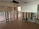 A peek into an open living area with tile floors leading to a renovated bathroom at 13811 Michelle Ave, Hudson, FL 34667