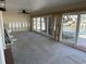 Sun room features sliding glass doors and large window framing the water view at 13811 Michelle Ave, Hudson, FL 34667