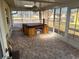 Enclosed sunroom featuring a brick floor and jacuzzi at 13811 Michelle Ave, Hudson, FL 34667