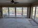 Water view through the bright sunroom with sliding glass doors leading to the outdoor canal at 13811 Michelle Ave, Hudson, FL 34667
