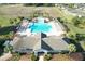 Birds eye view of a community pool, complete with cabanas, lounge chairs, and beautiful surrounding landscaping at 14581 Wake Robin Dr, Brooksville, FL 34604