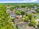 Aerial view of a neighborhood with mature landscaping and blue skies and a house with solar panels at 14581 Wake Robin Dr, Brooksville, FL 34604