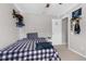 Comfortable bedroom with ceiling fan, decor and a black and white patterned comforter at 14581 Wake Robin Dr, Brooksville, FL 34604
