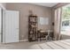 Bedroom featuring a cozy desk area, bookshelf, neutral walls, and a bright window at 14581 Wake Robin Dr, Brooksville, FL 34604