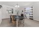 Bright dining room with a large oval table and views to living area at 14581 Wake Robin Dr, Brooksville, FL 34604