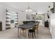 Bright dining area with a black table, stylish chairs, and an adjacent open-concept living room at 14581 Wake Robin Dr, Brooksville, FL 34604