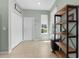 Inviting entryway features front door, neutral walls, tile floors and useful wood shelving unit at 14581 Wake Robin Dr, Brooksville, FL 34604