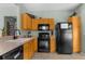 Functional kitchen with black appliances and ample wood cabinet space at 14581 Wake Robin Dr, Brooksville, FL 34604
