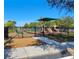 Community playground with a slide, a covered play structure, and a bench in a fenced-in area at 14581 Wake Robin Dr, Brooksville, FL 34604