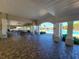 View of the community pool from inside a pool pavilion with picnic tables and multiple archways at 14581 Wake Robin Dr, Brooksville, FL 34604