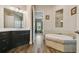 Well-lit bathroom featuring a soaking tub with decorative tile and access to the shower at 15912 42Nd E Gln, Parrish, FL 34219