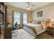 Comfortable bedroom with a ceiling fan, large windows, and a stylish desk and bookshelf at 15912 42Nd E Gln, Parrish, FL 34219