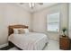 Bright bedroom featuring a queen-sized bed, a fluffy white rug, and a bedside table with decor at 15912 42Nd E Gln, Parrish, FL 34219