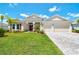 Charming single-story home with lush landscaping, a well-manicured lawn, and a two-car garage at 15912 42Nd E Gln, Parrish, FL 34219