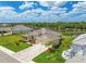 A beautiful single-Gathering home boasts a three-car garage, palm trees, and paver driveway at 15912 42Nd E Gln, Parrish, FL 34219