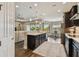 Bright, open kitchen showcasing modern appliances and seamless access to both the dining and living areas at 15912 42Nd E Gln, Parrish, FL 34219