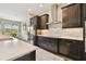 Modern kitchen featuring dark cabinets, stainless steel appliances, and a stylish backsplash at 15912 42Nd E Gln, Parrish, FL 34219