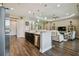 Open-concept kitchen boasts modern appliances, island seating, and seamless transition to the living area at 15912 42Nd E Gln, Parrish, FL 34219