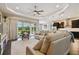Spacious living room with tray ceiling, neutral color palette, and sliding glass doors to backyard at 15912 42Nd E Gln, Parrish, FL 34219