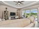 Cozy living area with a fireplace, backyard views, and neutral tones provides relaxation and style at 15912 42Nd E Gln, Parrish, FL 34219