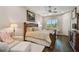 Inviting main bedroom with a decorative headboard, comfortable seating, and natural light at 15912 42Nd E Gln, Parrish, FL 34219