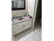 Bathroom with a vanity, stone countertop, white cabinets and tile floor at 1704 Winn Arthur Dr, Valrico, FL 33594