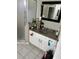 Bathroom vanity featuring granite counters, white cabinets, and a dark framed mirror at 1704 Winn Arthur Dr, Valrico, FL 33594