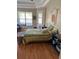 Cozy bedroom featuring a queen bed with decorative quilt, neutral paint, and access to a small balcony at 1704 Winn Arthur Dr, Valrico, FL 33594