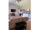 Bright living room with ceiling fan, TV, built-in bookcase and laminate wood flooring for a modern touch at 1704 Winn Arthur Dr, Valrico, FL 33594