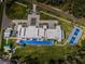 An aerial view of the property featuring manicured lawns, a long pool, tennis courts, and guest house at 18725 Jiretz Rd, Odessa, FL 33556