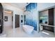 Modern bathroom features a standalone tub with blue tile accent wall and walk-in shower at 18725 Jiretz Rd, Odessa, FL 33556