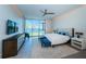 Luxurious bedroom with stunning lake views, a plush bed, and modern accents, offering a tranquil oasis at 18725 Jiretz Rd, Odessa, FL 33556