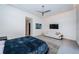 Modern main bedroom with comfortable king bed, white sofa and a light and airy ambiance at 18725 Jiretz Rd, Odessa, FL 33556
