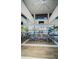 Open-concept dining area with chairs for many, high ceilings, overlooking the pool and water at 18725 Jiretz Rd, Odessa, FL 33556