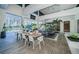 Large outdoor dining area and kitchen space with panoramic views of the lake and pool at 18725 Jiretz Rd, Odessa, FL 33556