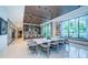 Chic dining area with a large table, stylish chairs, and expansive windows showcasing picturesque views at 18725 Jiretz Rd, Odessa, FL 33556