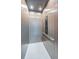 The inside of a modern elevator with sleek wood finishes, tile flooring, and accessible controls at 18725 Jiretz Rd, Odessa, FL 33556