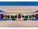 Elegant home entrance showcasing contemporary lighting, a grand doorway, and lush tropical landscaping at 18725 Jiretz Rd, Odessa, FL 33556