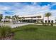 Expansive modern home featuring well-manicured lawn, a circular driveway, and a captivating water feature at 18725 Jiretz Rd, Odessa, FL 33556
