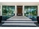 Elegant entrance with water feature and modern glass architecture, creating a welcoming and sophisticated curb appeal at 18725 Jiretz Rd, Odessa, FL 33556
