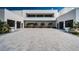 Contemporary home featuring a large driveway, with a clean design and well-maintained landscaping at 18725 Jiretz Rd, Odessa, FL 33556