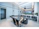 Game room with a custom poker table, bar area, and stylish lighting fixtures at 18725 Jiretz Rd, Odessa, FL 33556