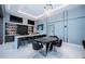 Entertaining game room featuring a poker table, bar, and wall-mounted TVs for entertainment at 18725 Jiretz Rd, Odessa, FL 33556