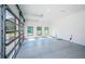 Clean, spacious three-car garage with glass doors and neutral-toned walls at 18725 Jiretz Rd, Odessa, FL 33556