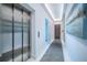 Modern hallway featuring herringbone floors, an elevator, recessed lighting, and artwork on the walls at 18725 Jiretz Rd, Odessa, FL 33556