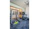 Well-equipped home gym with weight machines, treadmill, and large windows, creating an ideal fitness space at 18725 Jiretz Rd, Odessa, FL 33556